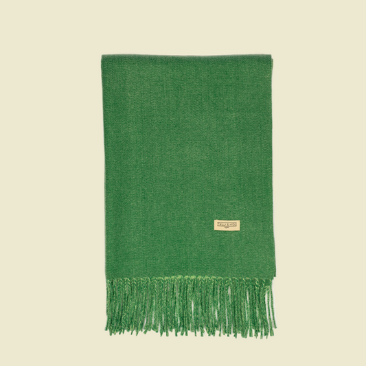 Green scarf with fringes on a white background
